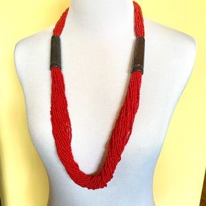 Multi strand red bead necklace with carved wood details